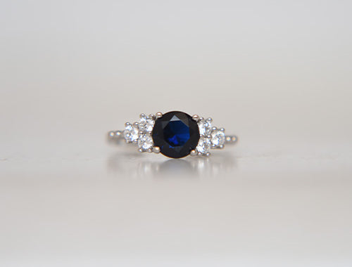 Round Cut Dark Blue Stone With 3 Side Stone Ring